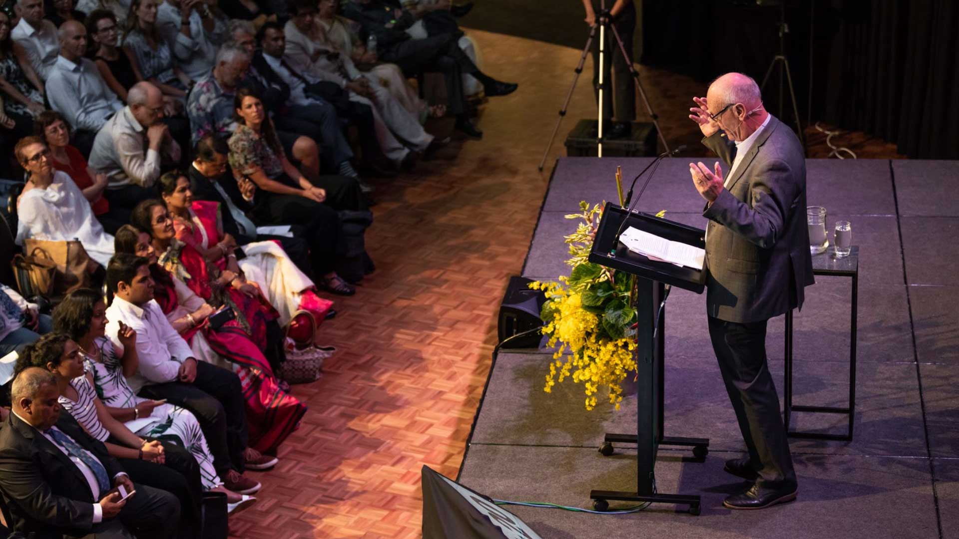 Tim Costello talking on stage at the Roundhouse