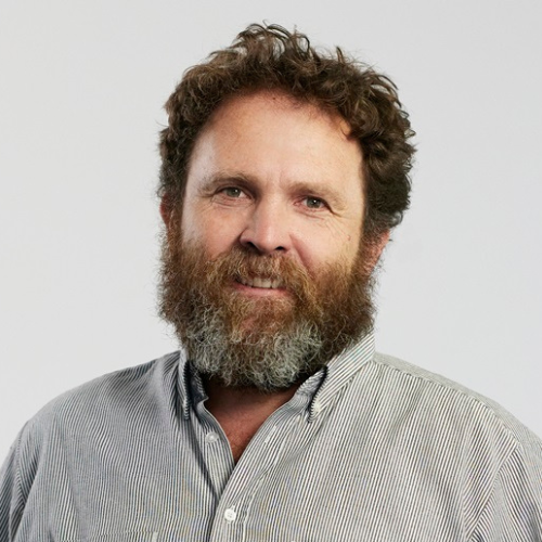 Headshot of Saul Griffiths in a grey button down shirt. 