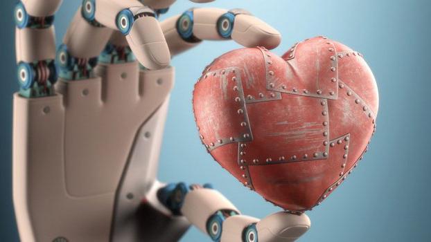 phot of wooden model hand holding a metal heart