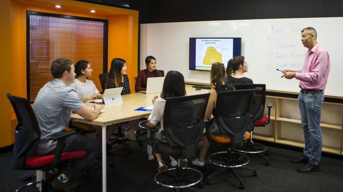 photo of students sitting in a workshop