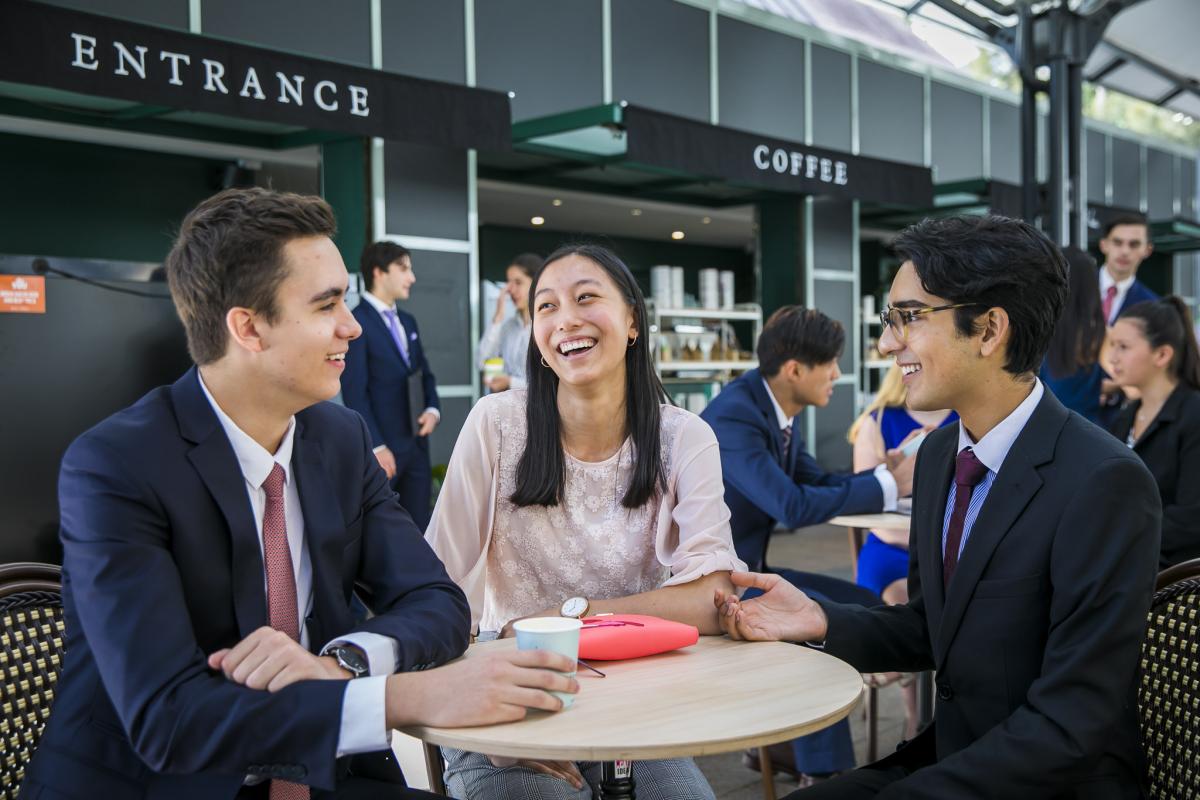 photo of young people sittgn around a table