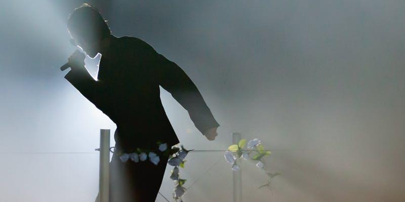 phot of a shadowy figure on stage with smoke