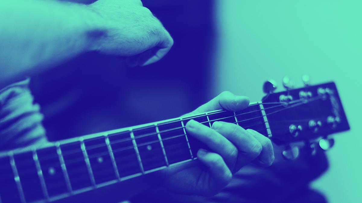 hands playing a guitar