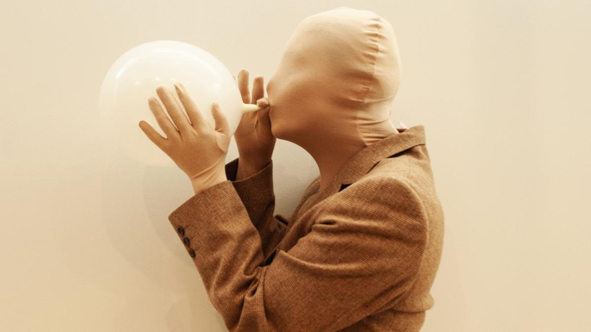 body blowing up a balloon