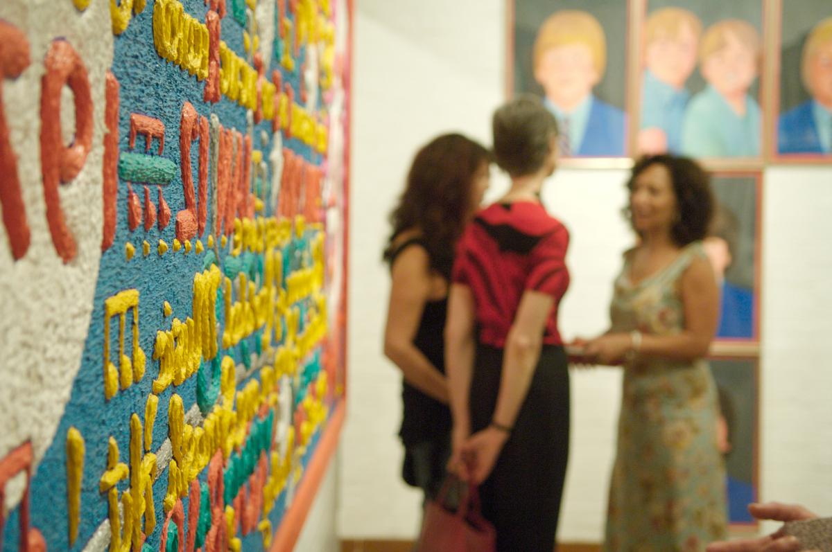 photo of people looking at art