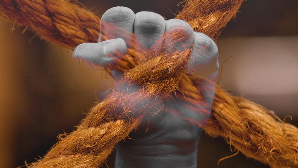 abstract image of hand making a fist overlaid on an image of rope