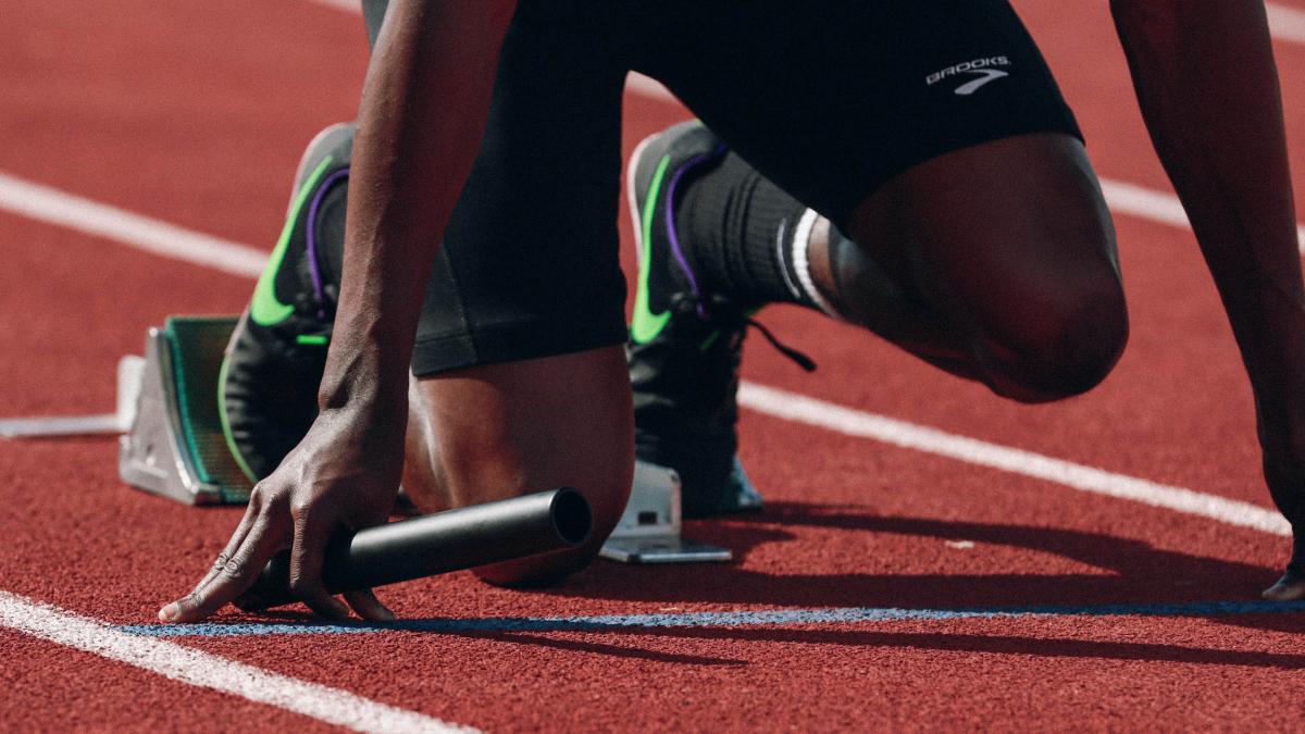 photo of a track field athlete torso at the starting blocks