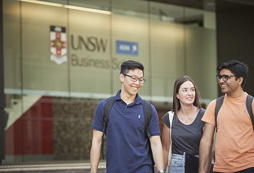 photo of young people walking outside a building