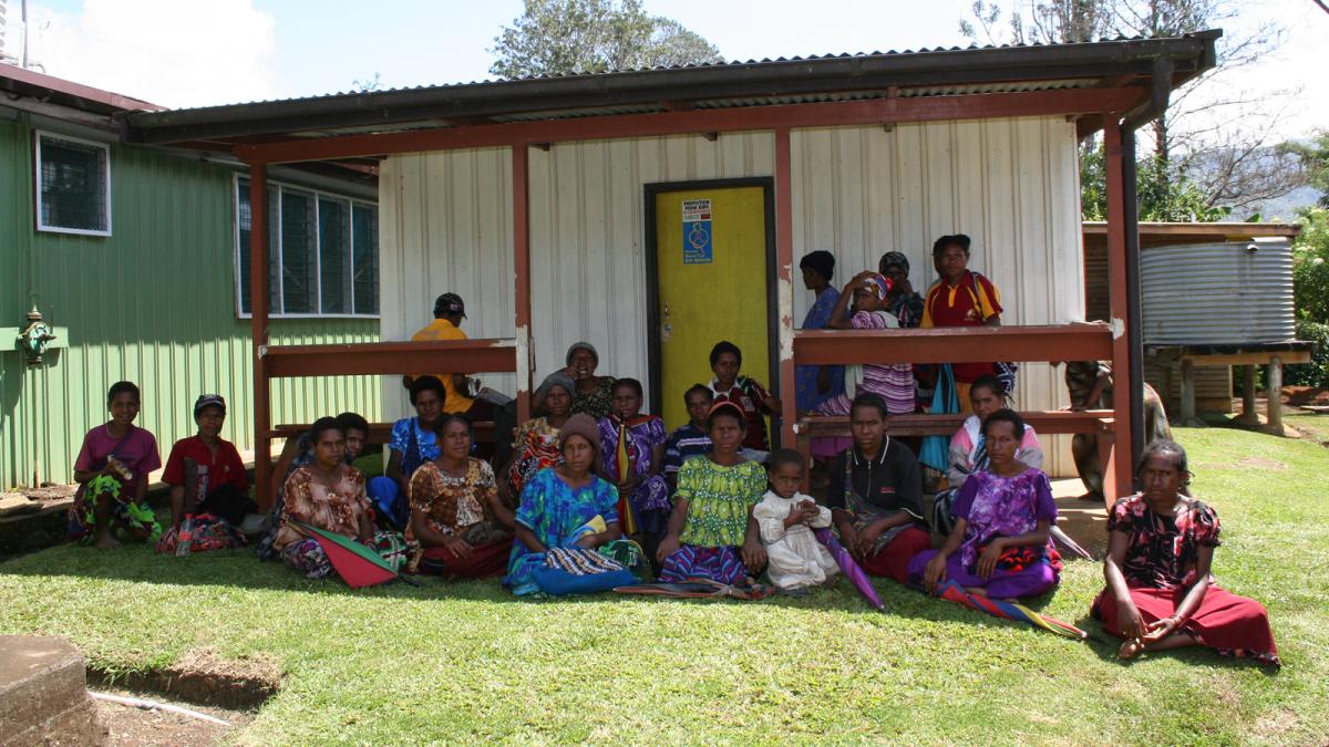 photo of a group of people sitting outside a buidling