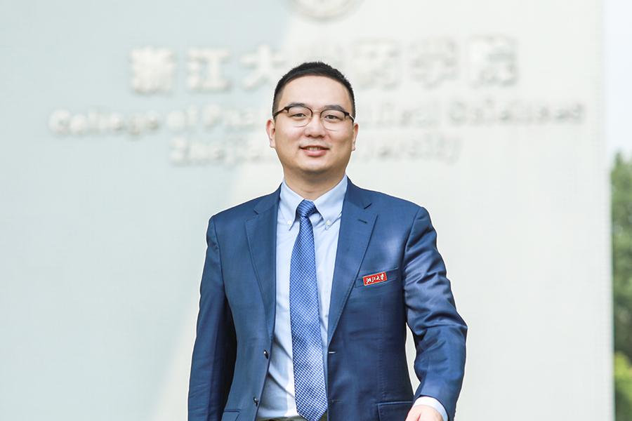 photo of man in suit against a white wall
