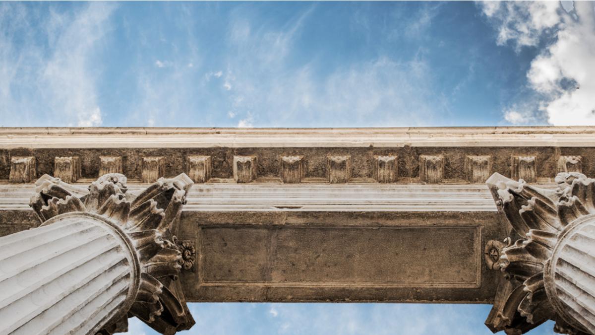 View of cement structure with columns as seen from the ground looking up